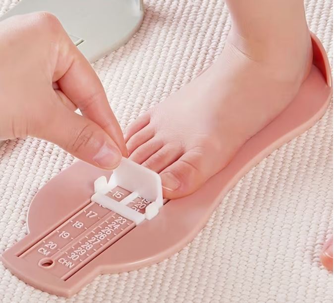 종이와 자로 아기 발 길이를 재는 장면